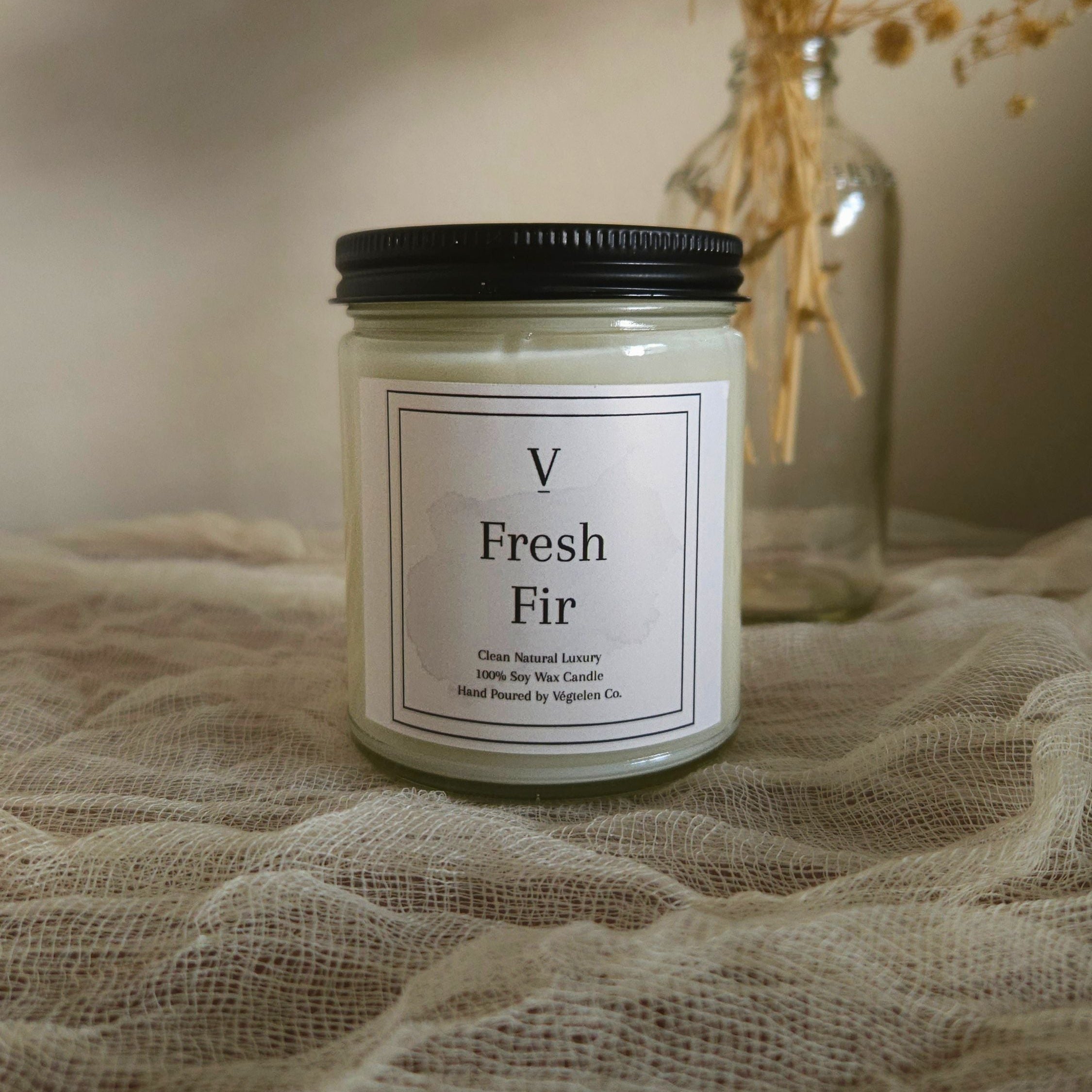 Luxury evergreen candle creating cozy winter atmosphere in modern home